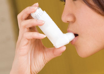 Person using inhaler.