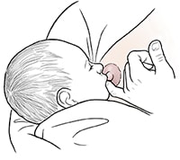 Female using finger to release nursing baby from breast.