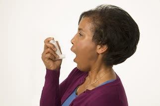 Person holding inhaler, preparing to use it